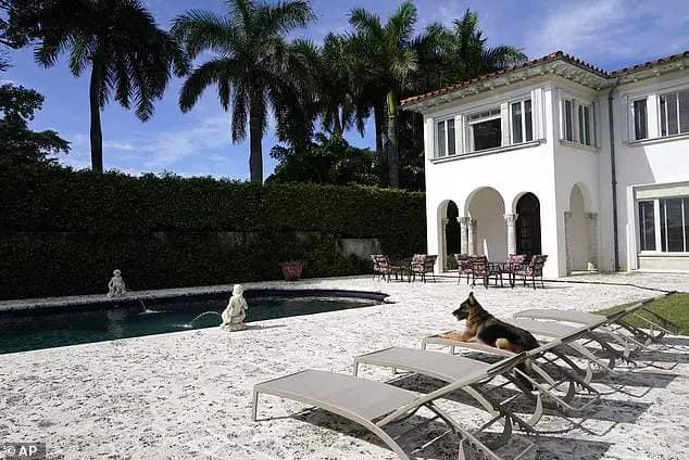 German Shepherd Gunther VI sits by the pool at a house formally owned by pop star Madonna in 2021. The claim that the dog was selling the mansion tricked many journalists