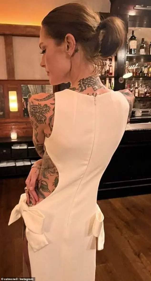 Cat also posted a back shot of her unique dress as the couple enjoyed a casual reception at a New York bar