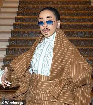 Quirky: In the mood of couture, the singer, 27, once again made a bold statement as she arrived with stick on eyebrows, a moustache and goatee