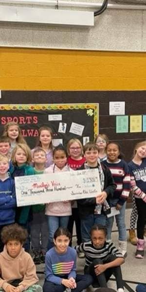 Sunview Elem. School students hold check 1-23