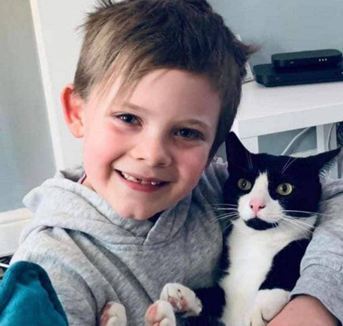 Elliott Gower with his best friend Oreo before the young cat was shot in Margate. Picture: Jodie Gower