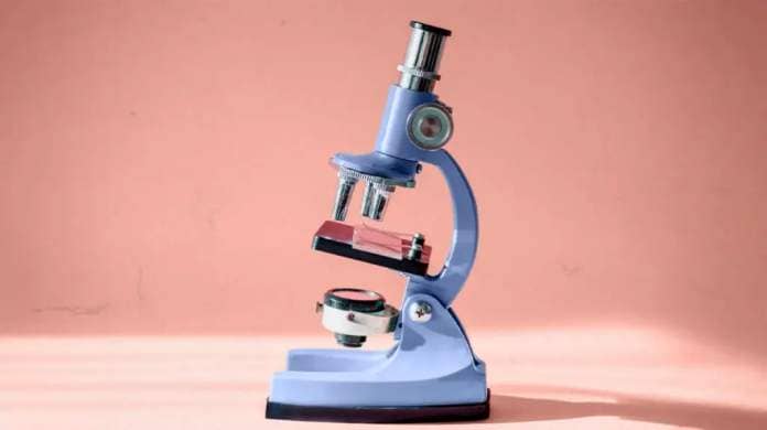 blue microscope on peach colored background