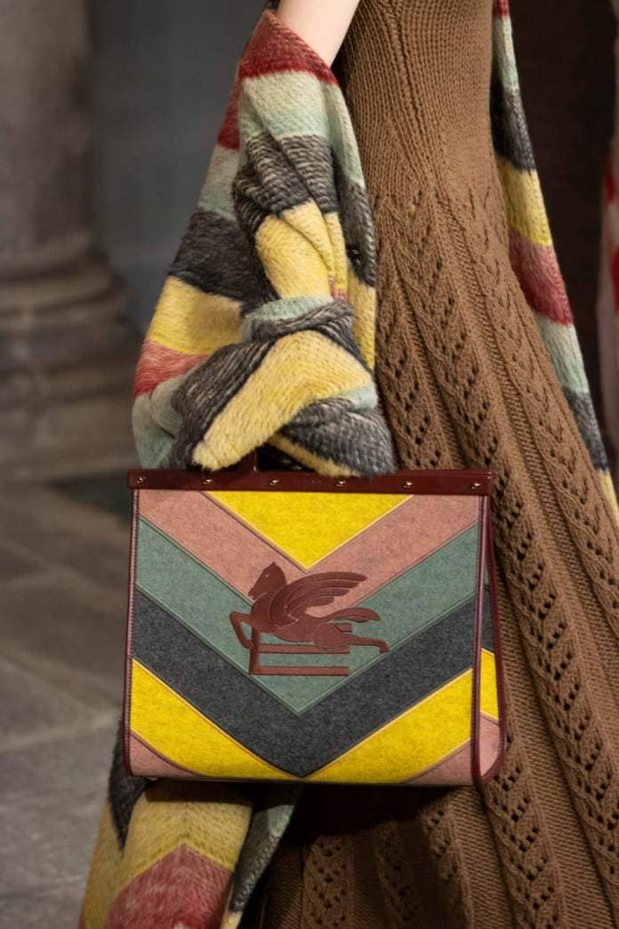 A suede striped bag and matching knitwear from Etro fall winter ’23. - Credit: Gamma-Rapho via Getty Images