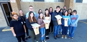 Members of the Chatham-Kent Secondary School Environmental Club display some of the blue bird boxes they constructed as part of a stewardship project with the Lower Thames Valley Conservation Authority. (Ellwood Shreve/Chatham Daily News)