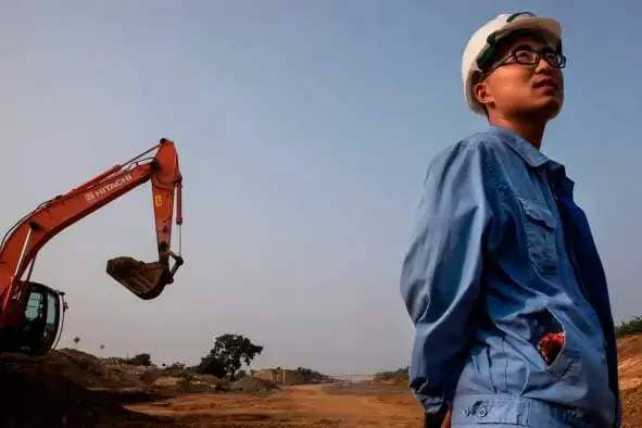 Chinese engineer standing in front of a development site