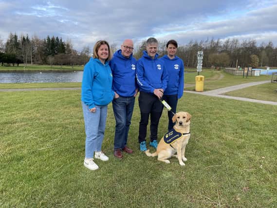 Organiser Robert Lindsay and other volunteers meeting Mary, the guide dog puppy