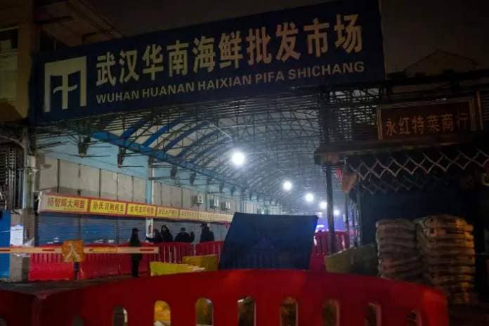 Security guards stand in front of the closed Huanan Seafood Wholesale Market in the city of Wuhan on Jan. 11, 2020.
