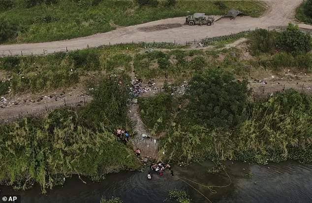 Migrants cross the Rio Grande river into the United States from Matamoros, Mexico