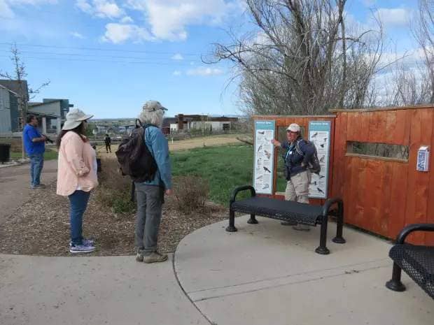 Linda Lee leads a bird walk at Hecla Lake Sunday and she shows the birds common to the area. (Andrea Grajeda/ Staff Writer)