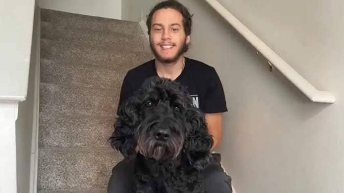 Justin Fuller with his Ace, his goldendoodle.