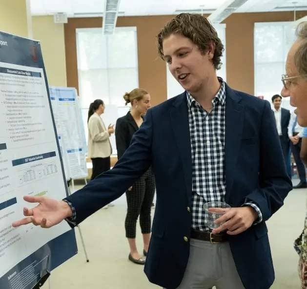 Economics major Ryan Hayes '23 presents his research, "Understanding GlobalFoundries - Initiation of Coverage Report," during a poster session as part of the Steinmetz Symposium on May 12, 2023.