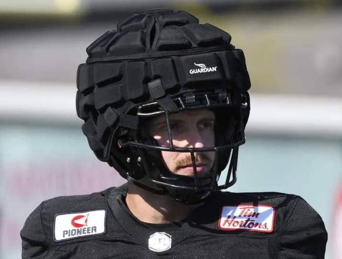 Ticat Bailey Feltmate wears a Guardian Cap, a soft-shell helmet cover, at practice Thursday.