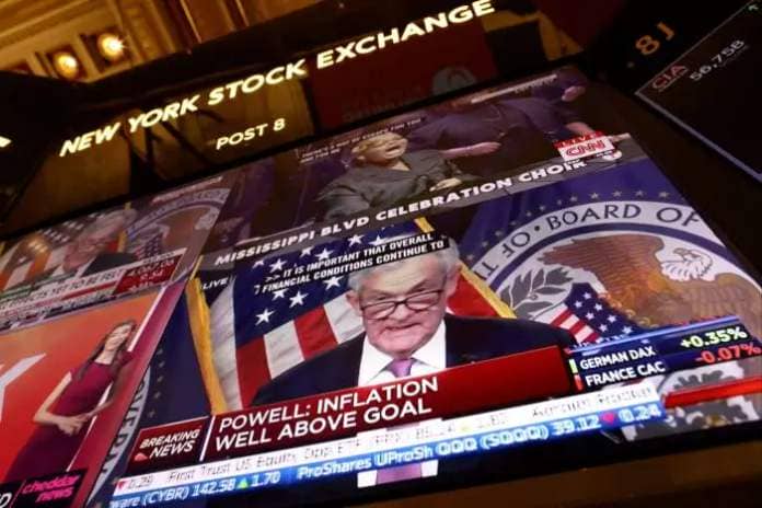 Federal Reserve Board chairman Jerome Powell appears on a screen on the trading floor of the New York Stock Exchange 