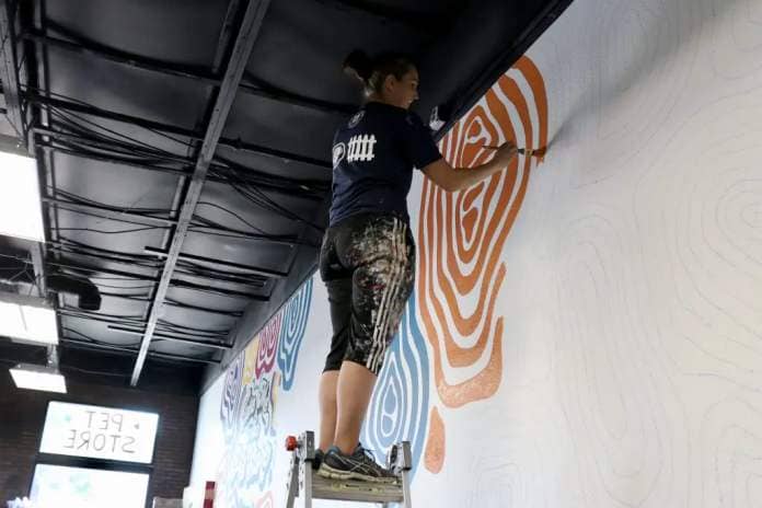 Emily Staheli paints wall art inside Whisker and Bone in St. George, Utah, May 18, 2023 | Photo by Jessi Bang, St. George News