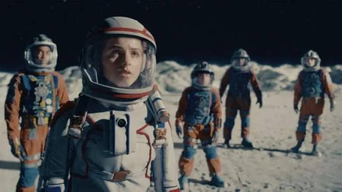 a group of kids in space suits stand on the moon and look into the distance in a scene from crater, a good housekeeping pick for best kids movies 2023