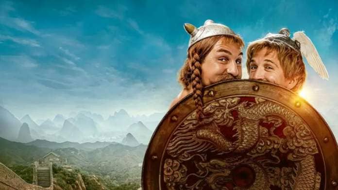 ast&#xe9;rix ob&#xe9;lix smirk behind a shield in a promotional image for ast&#xe9;rix ob&#xe9;lix the middle kingdom, a good housekeeping pick for best kids&#39; movies 2023