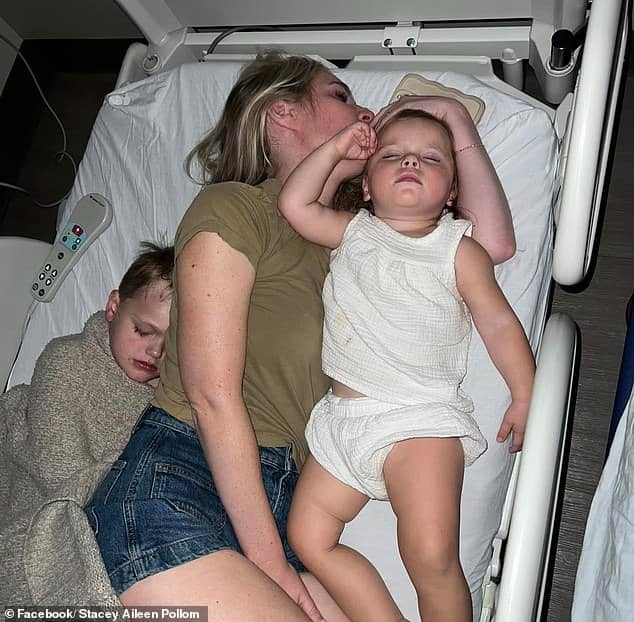 Jad (left), sleeps in a hospital bed with his mother and his sibling after being treated for a copperhead snake bite