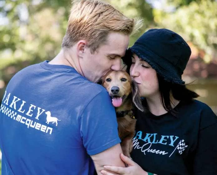 Oakley McQueen with his paw-rents Coleman, left, and Rylee Vanderhorst, who are supporting him with customized shirts. Habeba Mostafa/ The Signal