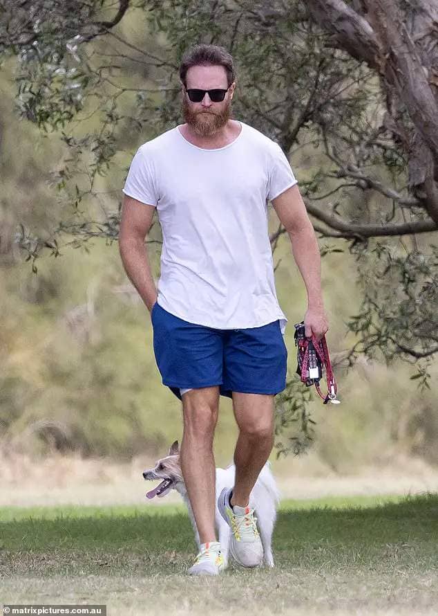 Australian actor Josh Lawson (pictured) cut a grim figure on Sunday as he took his dog for a walk in the Gold Coast, in the wake of his shock cheating scandal