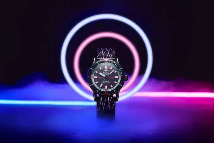 a brightly colored watch with fog and lasers in the background 