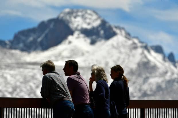 Rocky Mountain National Park visitors take in the view of Longs Peak and other well-known peaks at Many Parks Curve Overlook along Trail Ridge Road in Rocky Mountain National Park in 2022. (File Photo)