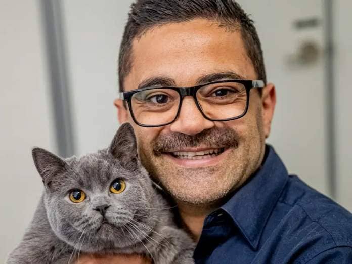 A veterinarian holding a cat