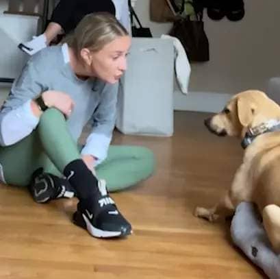 A woman teaches her dog to say, "I love you."
