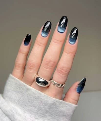 This vintage-inspired cat eye manicure features glittery half moon details.