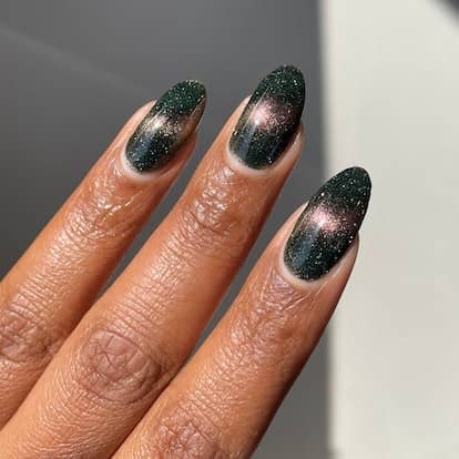 These galaxy-inspired cat eye nails are trending.