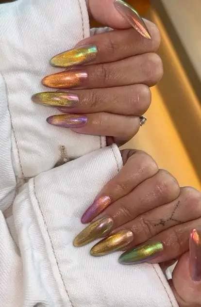 Vanessa Hudgens' colorful chrome nails are inspiration for a cat eye manicure.