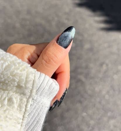 This optical illusion French tip manicure is reminiscent of the cat eye nail art trend.