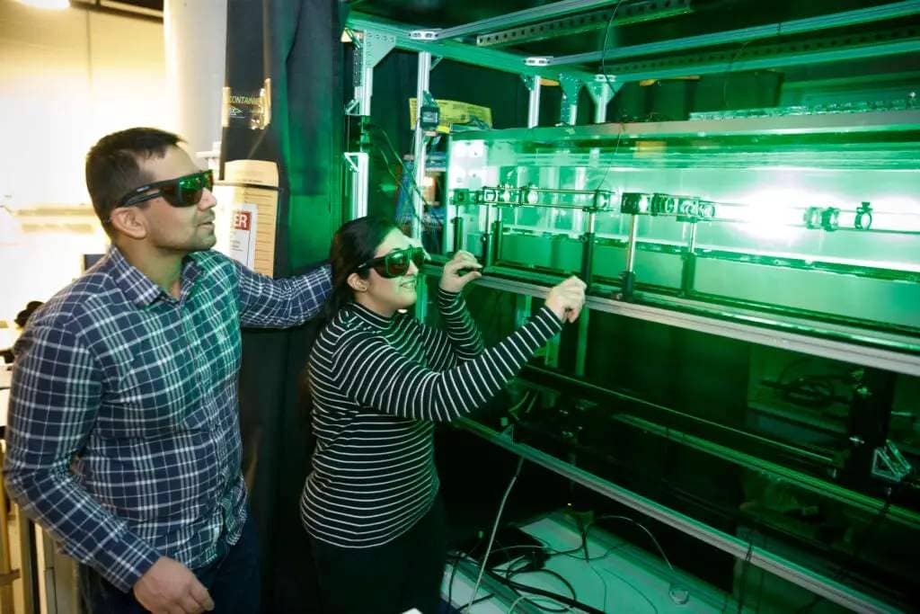 Prasoon Suchandra (left) and Shabnam Raayai working with lasers in their lab.