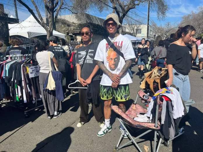 Shaundy Ravanal, left, and Jessie Diez at the front of their booth called “Chasin’ Nostalgia.” FIT CHECK: Diez is wearing a 1998 Dennis Rodman t-shirt from Ebay, Nike Spartan dunks and pants from his clothing brand called “5200.”