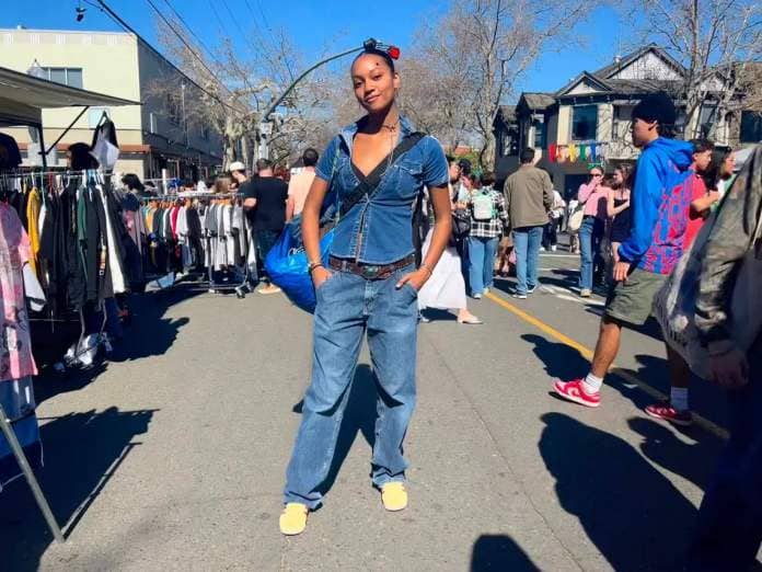 Jordyn Milan poses at World’s Worst Expo in midtown Sacramento. FIT CHECK: Milan is wearing thrifted Wrangler jeans, her sister’s belt, Adidas Gazelle shoes, a Baggu bag and an Ikea bag for all her items from the expo.