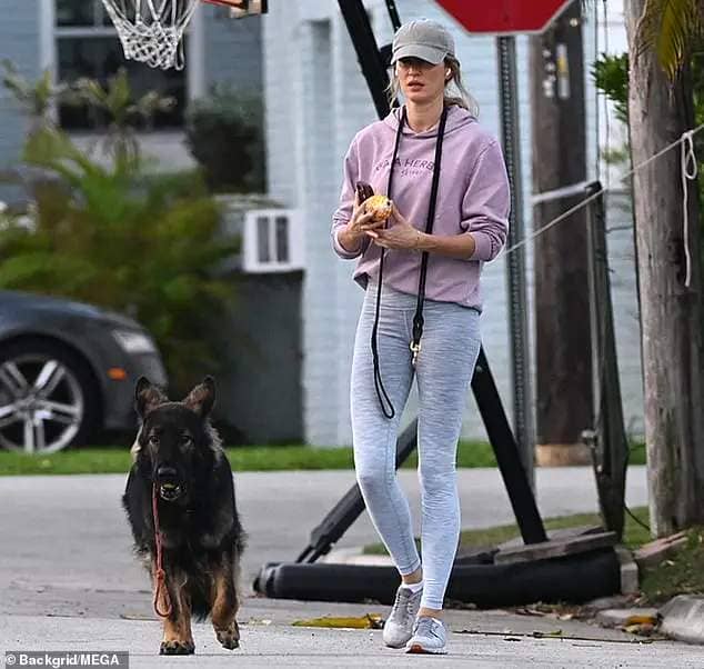 Gisele Bundchen looked relaxed while walking her dog in South Florida after an insider revealed she was 'deeply in love' with jiu-jitsu teacher Joaquim Valente