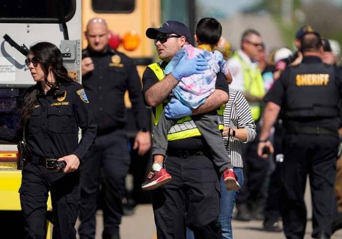 PHOTO: A boy is transported from a fatal school bus crash in Bastrop County, Texas, March 22, 2024.