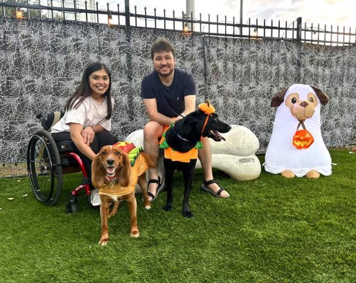 A couple enjoys a Halloween celebration with their dogs at Barks N Brews. The private park is located in Macon and offers a fenced-in park for dogs to run freely as well as an outdoor bar for dog owners.