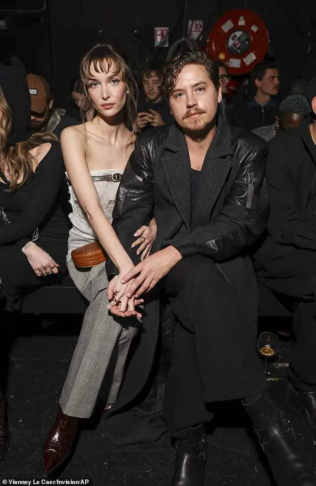 The loved-up couple couldn't keep their hands off one another as they sat front row with hands and arms interlinked