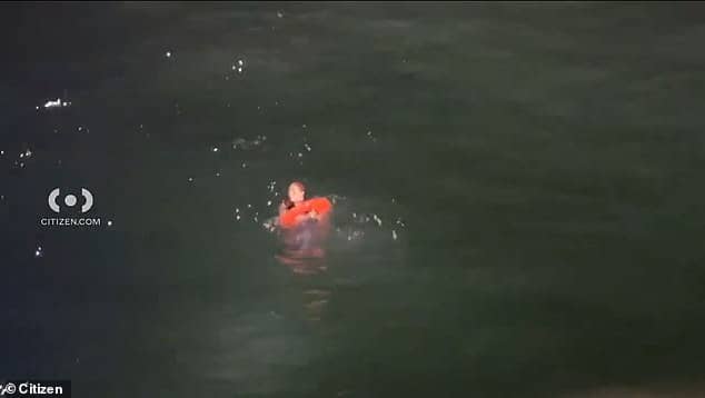 The woman was seen paddling in the water, while a Los Angeles Sheriff¿s Department boat attempted to rescue her by tossing a flotation donut into the ocean which she grabbed onto and was then hoisted onto the boat