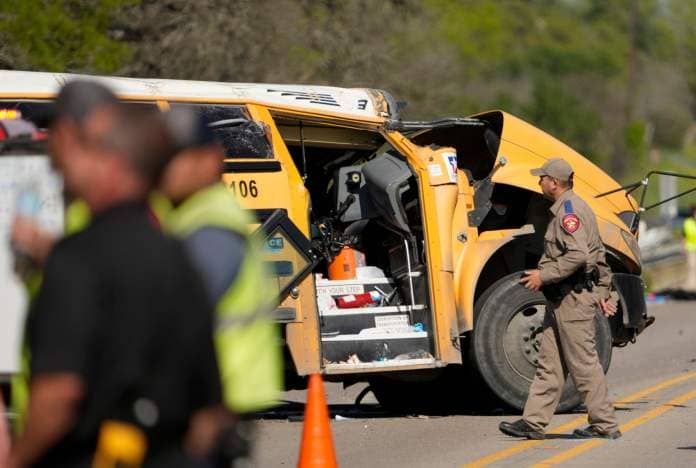 PHOTO: A DPS trooper looks at a school bus crash in Bastrop County, Texas, March 22, 2024.