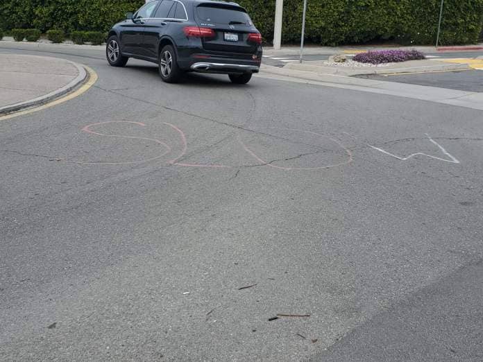 A variation of the recent "Slow down" messaging is placed on the street near a roundabout in Bird Rock.