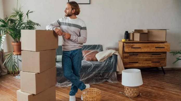 Man with boxes in new home