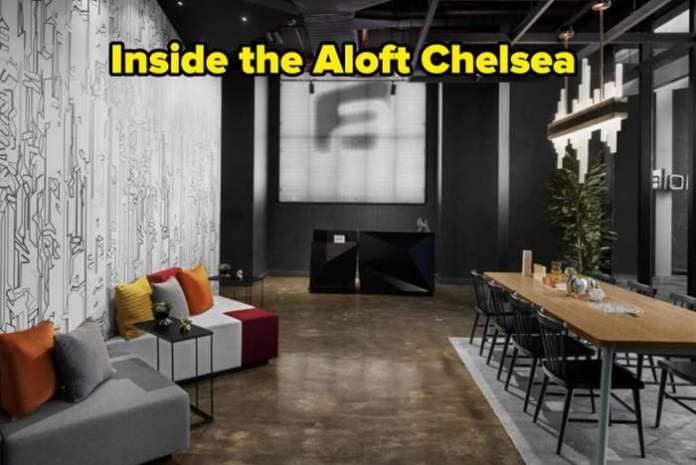 Modern hotel lobby with abstract wall art, mixed seating, and communal table with snacks