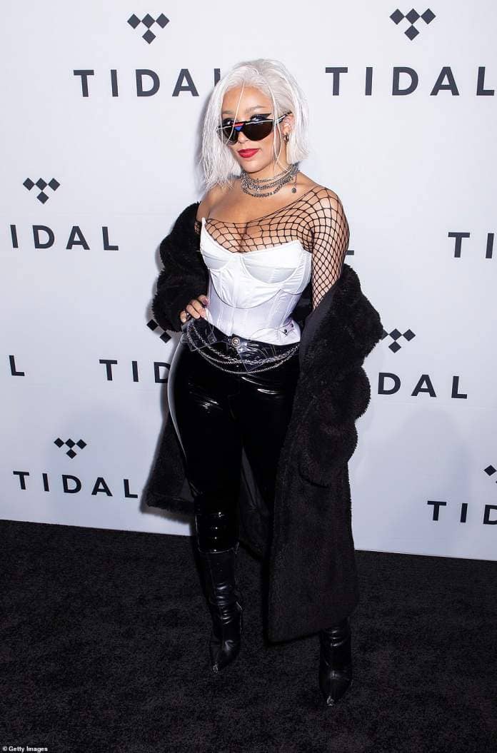 Doja cut an edgy figure in a white corset layered over a one-shoulder fishnet shirt while attending the 2019 Tidal X: The Rock the Vote Benefit Concert