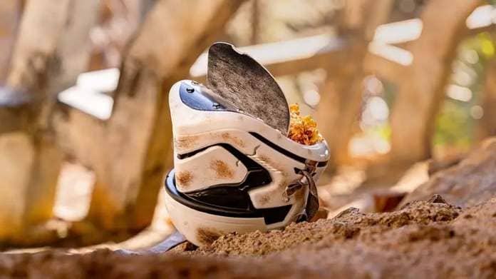 The Salvaged Stormtrooper Helmet Bucket sitting on the ground in Star Wars: Galaxy's Edge.
