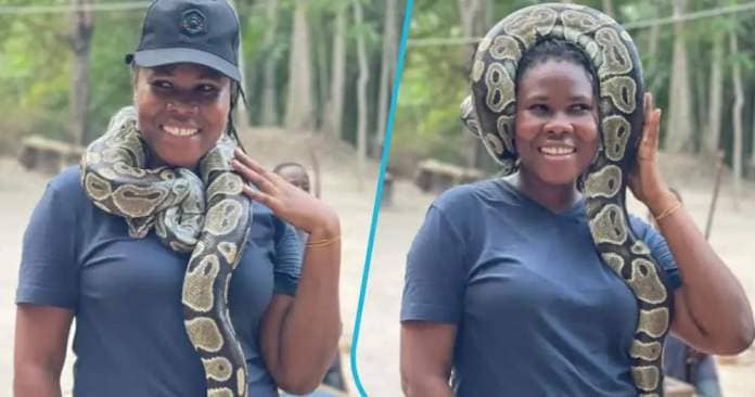 Lady poses with snake around her neck.