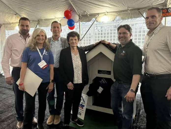 During the 2024 Long Island Builders Expo on Thursday, April 11, 2024, leadership and staff of Long Island Home Builders Care presented custom-built backyard dog dens which are being installed at the homes of two America's VetDogs program graduates, both veterans, and on the Amrerica's VetDogs and Guide Dog Foundation national training center campus in Smithtown, New York.