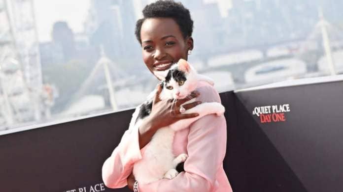 Lupita Nyong'o poses with cat Schnitzel at the London Photocall for "A Quiet Place: Day One" at IET Building: Savoy Place on May 1, 2024 in London, England.
