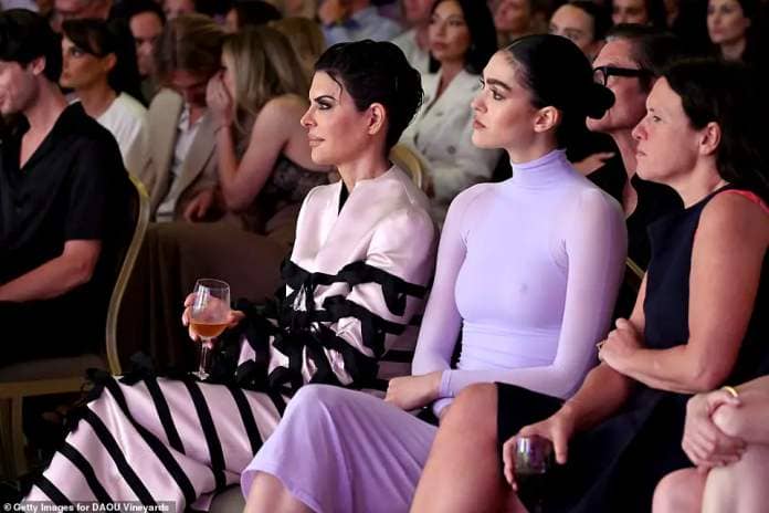 Amelia was spotted sitting next to her mother inside the swanky event