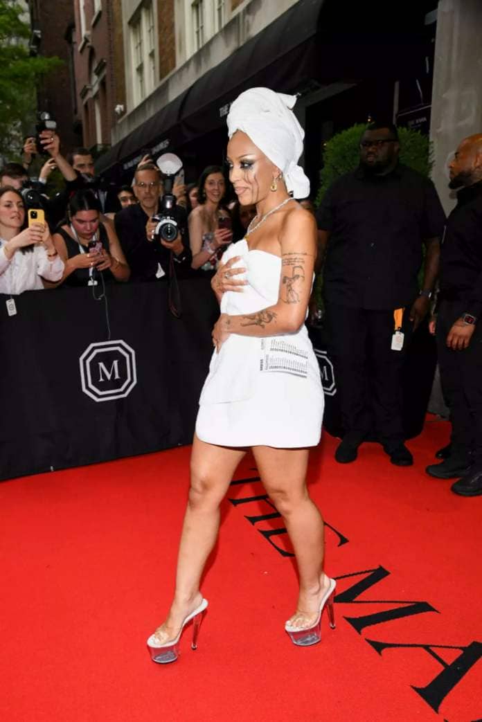 Doja Cat's first Met Gala outfit consisted of nothing but some clear heels and an.. erm.. towel? (Kristina Bumphrey/WWD via Getty Images)